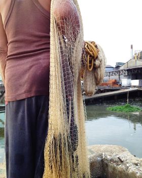 Fisherman pulling in his Fishing Net