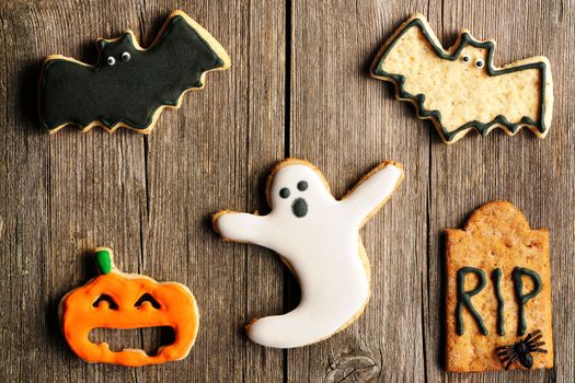 Halloween homemade gingerbread cookies over wooden table