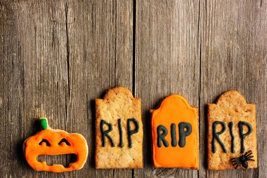 Halloween homemade gingerbread cookies over wooden table