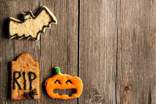 Halloween homemade gingerbread cookies over wooden table