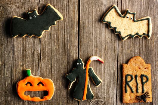 Halloween homemade gingerbread cookies over wooden table