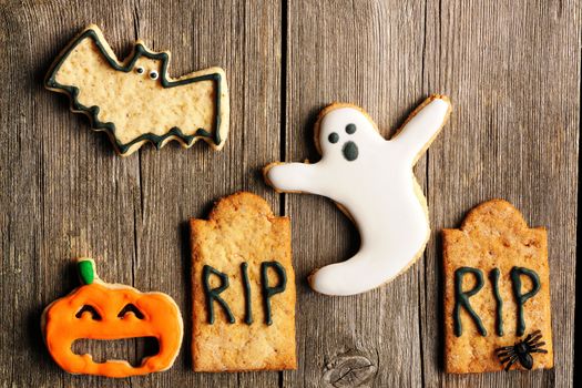 Halloween homemade gingerbread cookies over wooden table