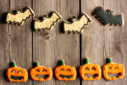 Halloween homemade gingerbread cookies over wooden table