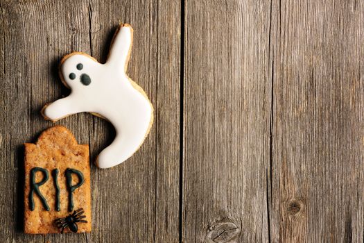 Halloween homemade gingerbread cookies over wooden table