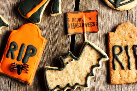 Halloween homemade gingerbread cookies over wooden table