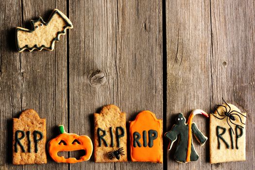 Halloween homemade gingerbread cookies over wooden table