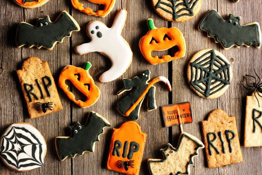 Halloween homemade gingerbread cookies over wooden table