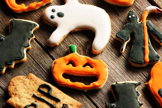 Halloween homemade gingerbread cookies over wooden table