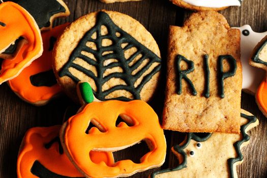 Halloween homemade gingerbread cookies over wooden table