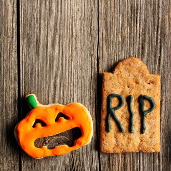 Halloween homemade gingerbread cookies over wooden table