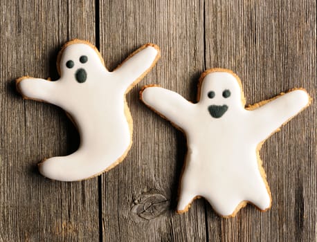 Halloween homemade gingerbread cookies over wooden table