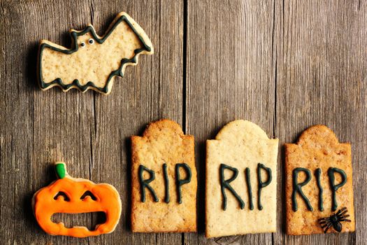 Halloween homemade gingerbread cookies over wooden table