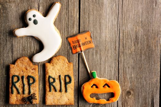 Halloween homemade gingerbread cookies over wooden table