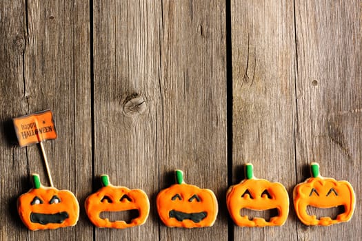 Halloween homemade gingerbread cookies over wooden table