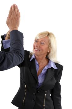 Senior businesswoman giving a high-five