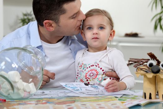 Man kissing his daughter