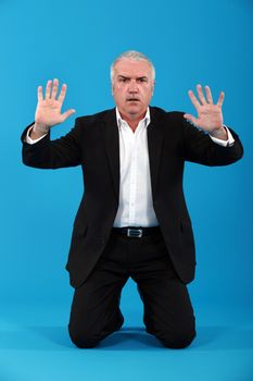 A businessman doing a mime.