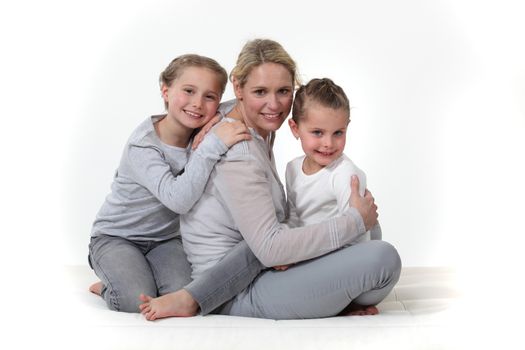 Woman hugging her children