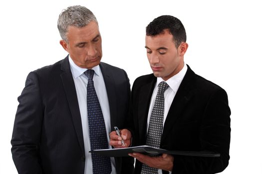 Businessmen looking at a clipboard