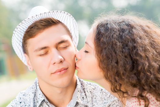 girl kissing a man on the cheek, spending time with loved ones