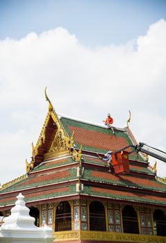 Men repair roof of Temple4