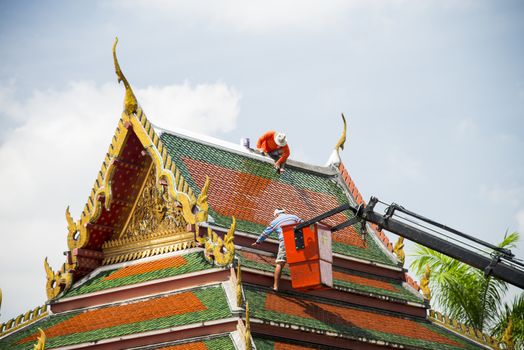 Men repair roof of Temple3