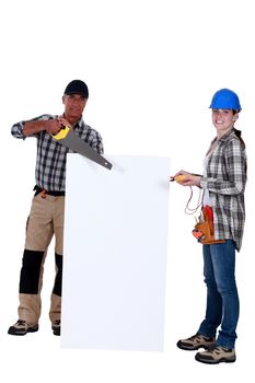 Carpenter and electrician with a blank board