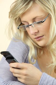 Woman wearing glasses sending a text message