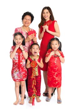 Group of happy  multi generations Asian Chinese family wishing you a happy Chinese New Year, with traditional Cheongsam standing isolated on white background.