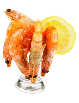 Cocktail of Delicious Fresh Shrimps with Lemon in Glass Stemware isolated on white background