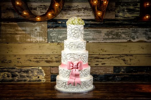 Image of a beautiful wedding cake with a rustic background