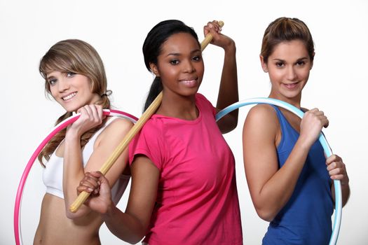 Three women limbering up at the gym