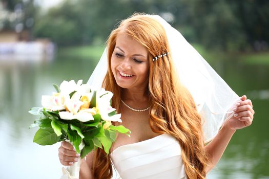 Portrait of beautiful bride with flowers