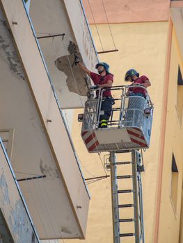 Firefighters working to put uncertainty of a cornice