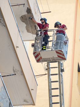 Firefighters working to put uncertainty of a cornice