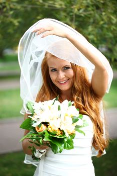 Portrait of beautiful bride with flowers