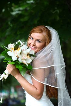 Portrait of beautiful bride with flowers