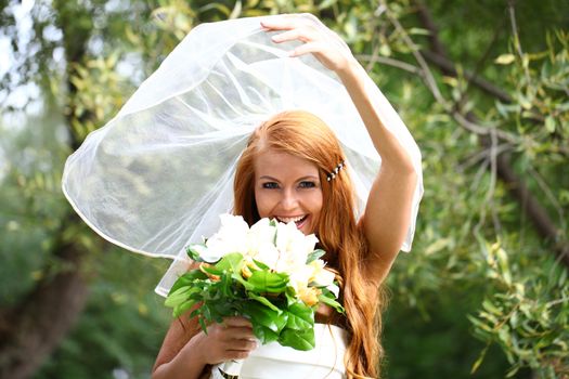 Portrait of beautiful bride with flowers