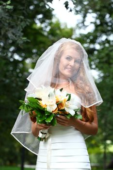 Portrait of beautiful bride with flowers