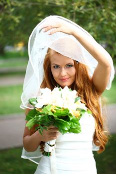 Portrait of beautiful bride with flowers