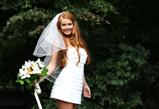 Portrait of beautiful bride with flowers