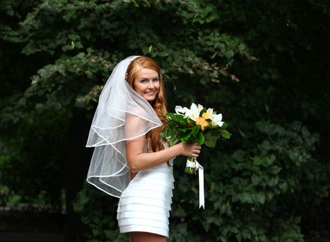 Portrait of beautiful bride with flowers