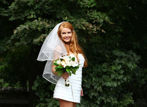 Portrait of beautiful bride with flowers