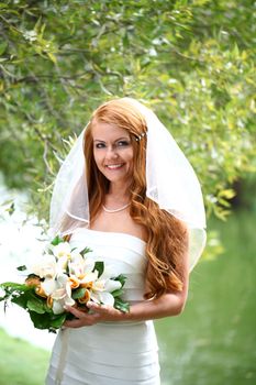 Portrait of beautiful bride with flowers