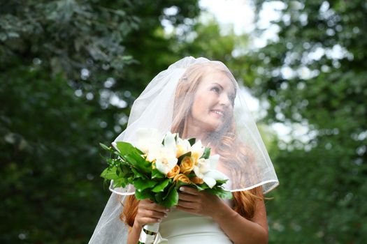 Portrait of beautiful bride with flowers