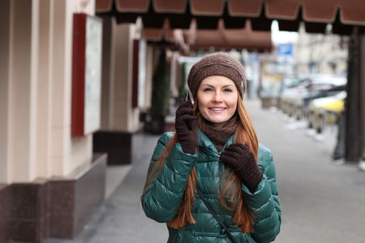 Happy young woman calling by phone