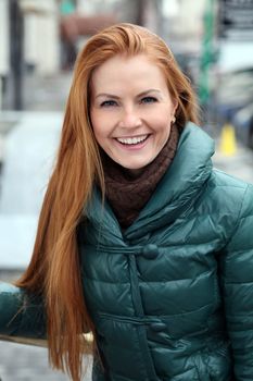 Happy young woman in autumn city