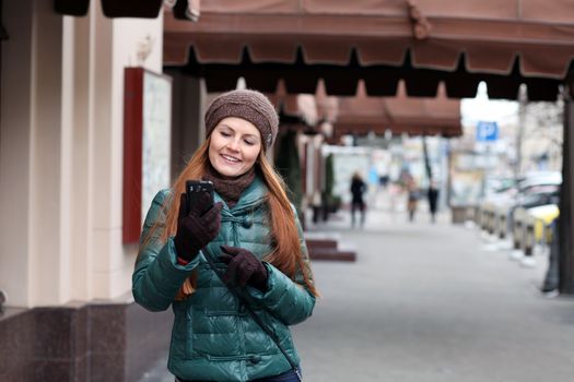 Happy young woman calling by phone