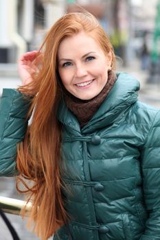 Happy young woman in autumn city