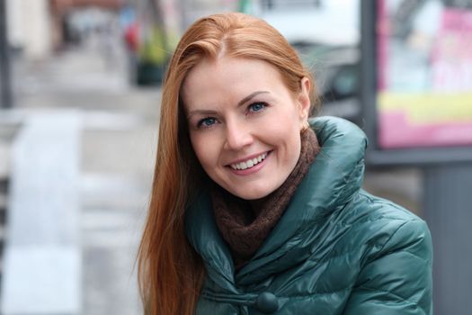 Happy young woman in autumn city